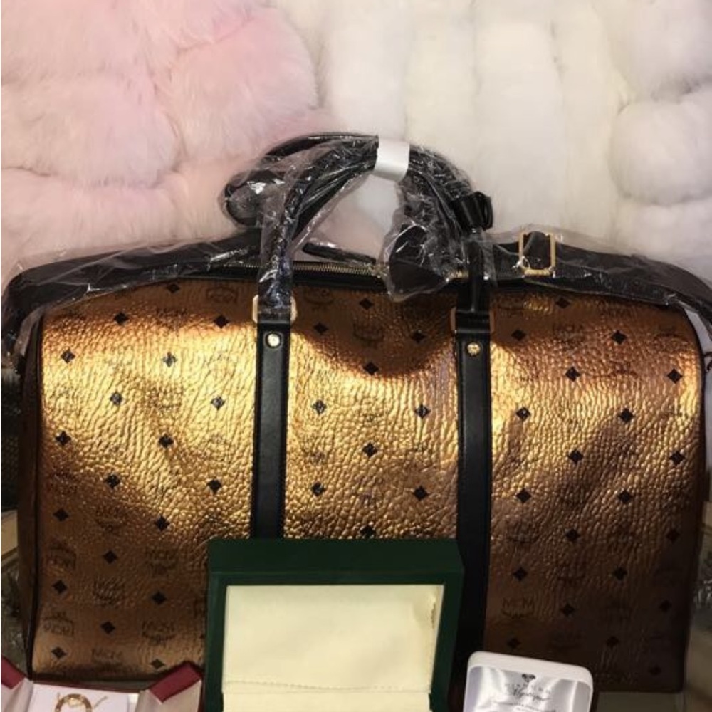 Mcm gold duffle never used with dust bag